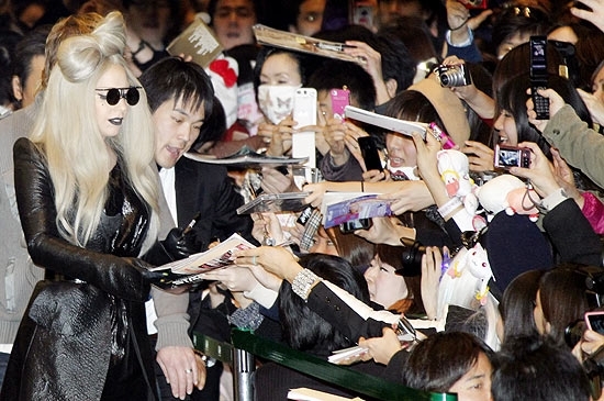 Lady Gaga atende fs no aeroporto de Tquio