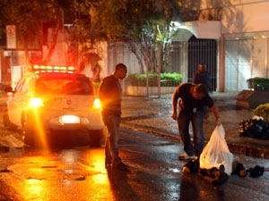 Policiais cobrem o corpo do homem morto durante tentativa de assalto em Ipanema